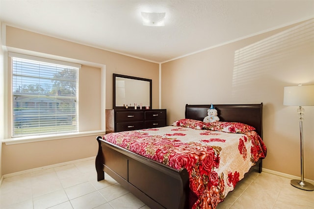 bedroom featuring crown molding and baseboards