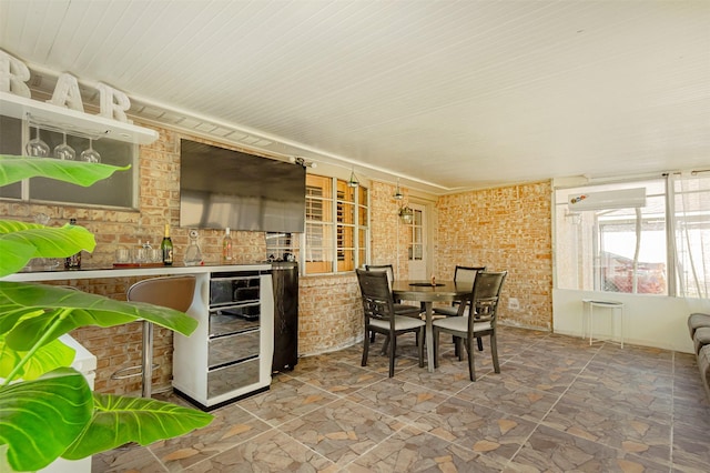 view of patio / terrace with beverage cooler, outdoor dining space, and area for grilling