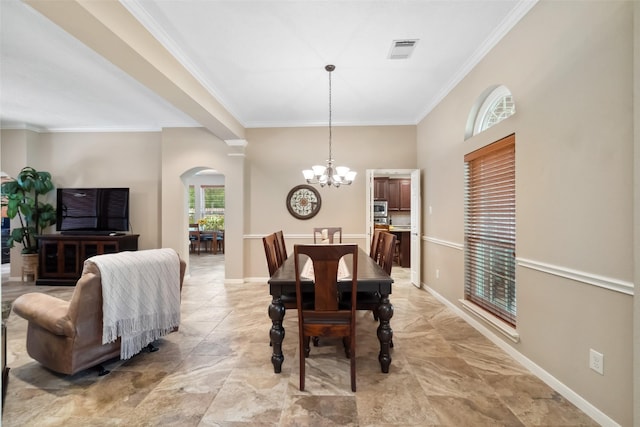 dining area with visible vents, baseboards, ornamental molding, an inviting chandelier, and arched walkways