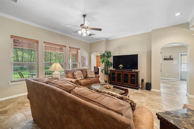 living room with arched walkways, a ceiling fan, crown molding, and baseboards