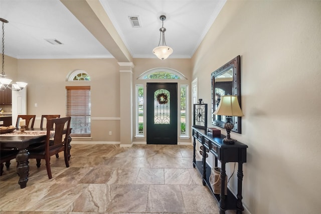 foyer with visible vents, baseboards, a chandelier, and ornamental molding