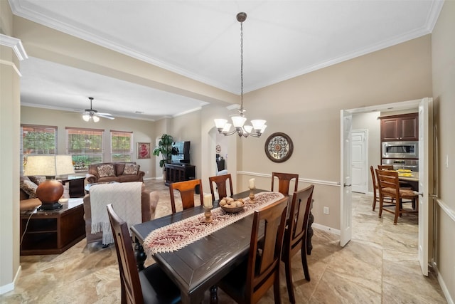 dining room with ceiling fan with notable chandelier, baseboards, and ornamental molding