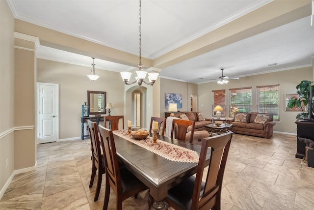 dining space with ceiling fan, baseboards, arched walkways, and ornamental molding