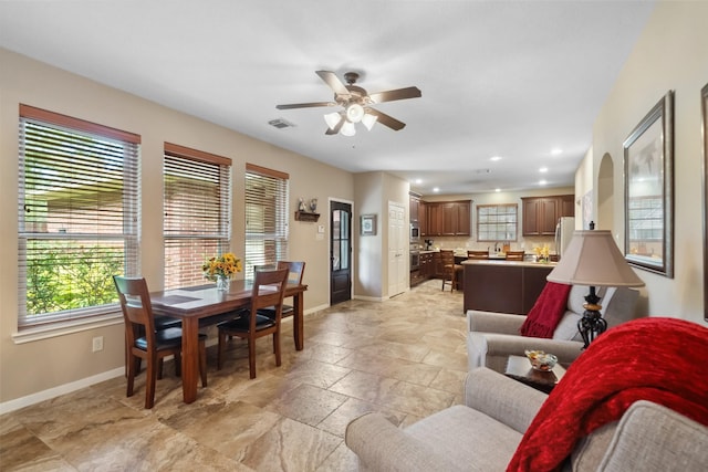 living area featuring recessed lighting, baseboards, stone tile floors, and a ceiling fan