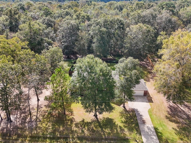 birds eye view of property featuring a view of trees