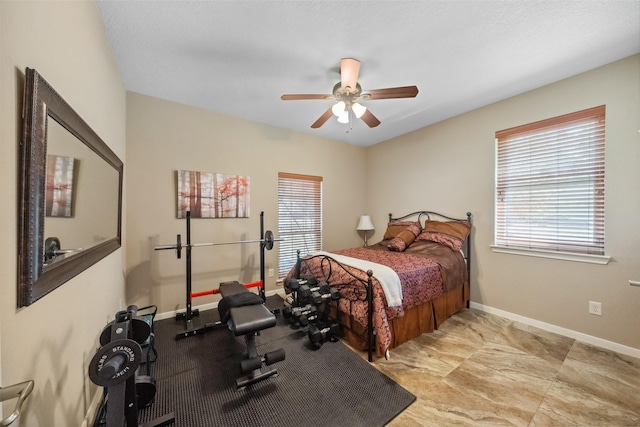 bedroom featuring a ceiling fan and baseboards