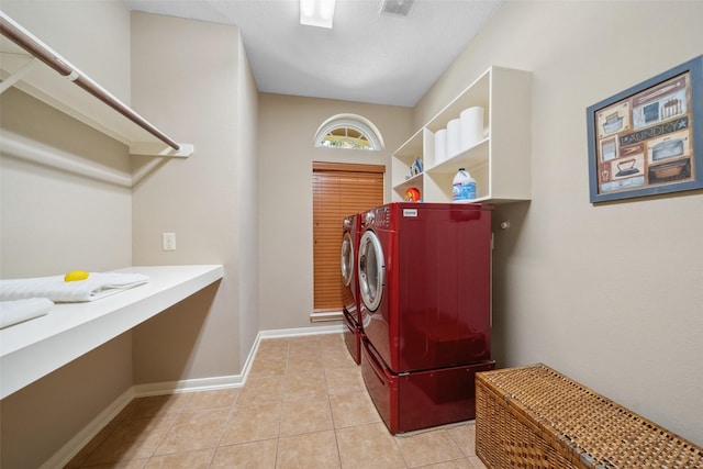 laundry area featuring visible vents, washer and clothes dryer, tile patterned flooring, baseboards, and laundry area