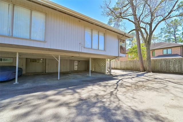 exterior space featuring covered parking and fence