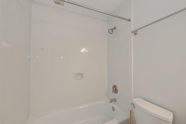 bathroom featuring toilet and bathing tub / shower combination