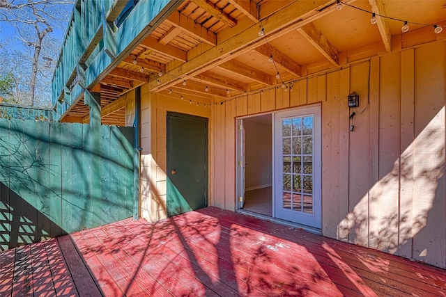 view of exterior entry featuring a deck