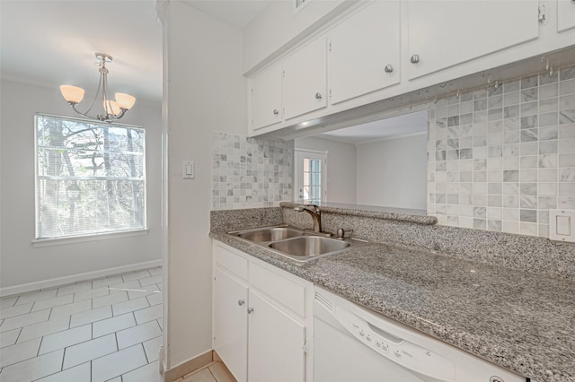 kitchen with dishwasher, decorative backsplash, a wealth of natural light, and a sink