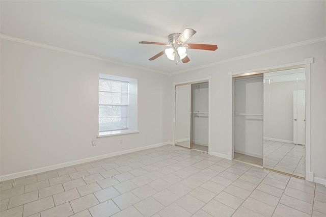 unfurnished bedroom with ceiling fan, baseboards, two closets, and ornamental molding