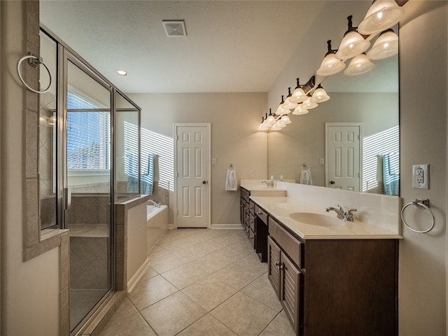 full bathroom featuring double vanity, a bath, visible vents, and a sink