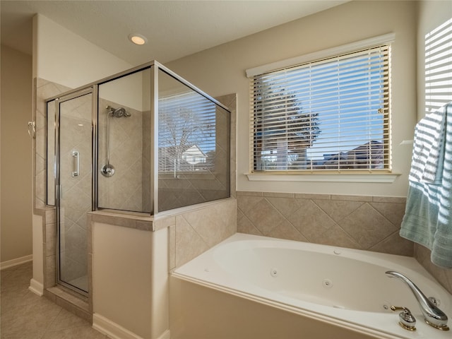 full bathroom with tile patterned floors, a tub with jets, and a stall shower