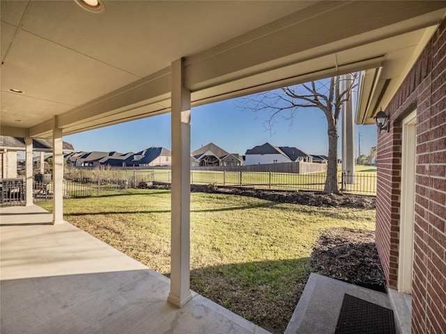 view of yard featuring a residential view, fence, and a patio area