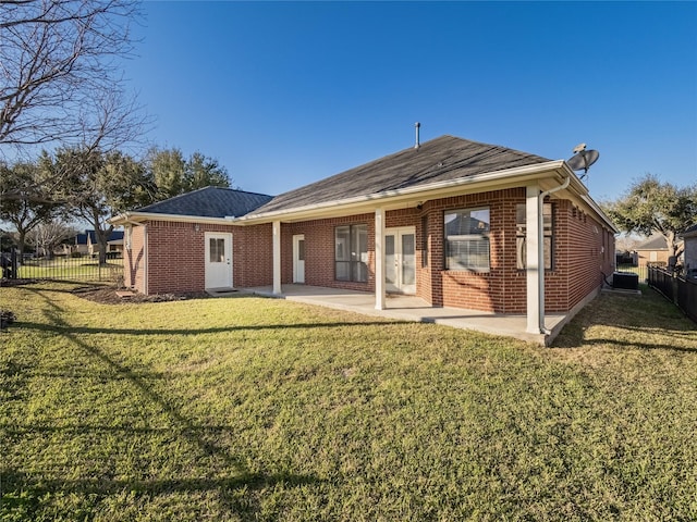 back of property with a patio, a yard, fence, and brick siding