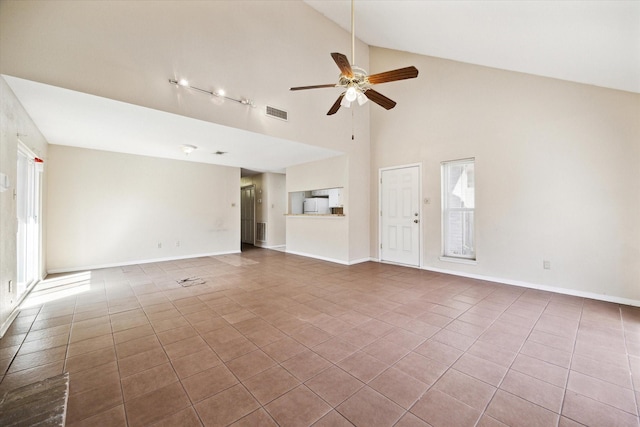 unfurnished living room with visible vents, baseboards, and a ceiling fan