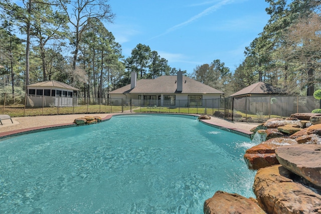 view of swimming pool featuring fence and a fenced in pool