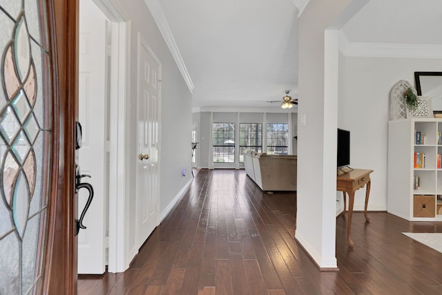 foyer with ceiling fan, dark wood-style floors, baseboards, and ornamental molding