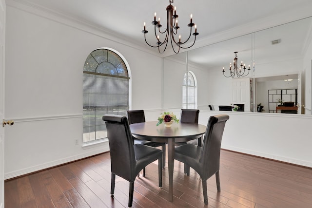 dining room with visible vents, dark wood-style flooring, a wealth of natural light, and ornamental molding