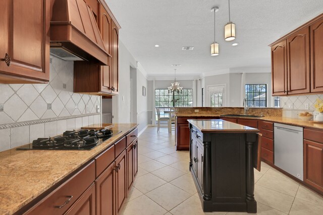 kitchen featuring dishwasher, custom range hood, pendant lighting, and a sink