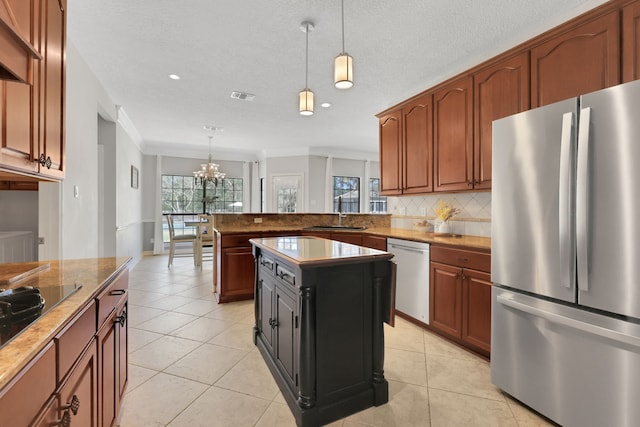 kitchen with light tile patterned floors, visible vents, backsplash, and stainless steel appliances