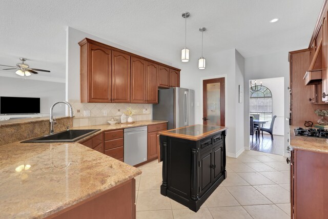 kitchen featuring a sink, stainless steel appliances, tasteful backsplash, and light tile patterned flooring