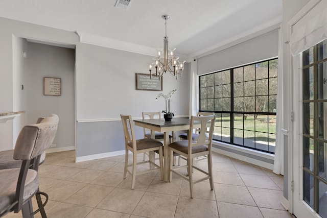 dining room with visible vents, crown molding, baseboards, a chandelier, and light tile patterned floors