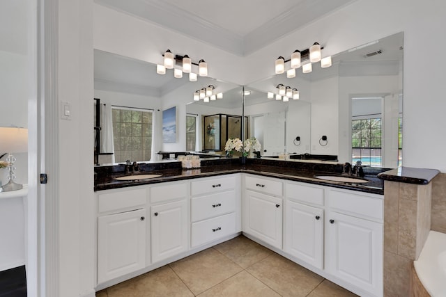 full bath with crown molding, visible vents, tile patterned floors, and a sink