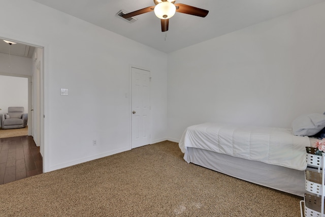 bedroom featuring visible vents, a ceiling fan, carpet flooring, baseboards, and attic access