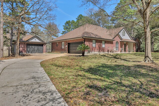 view of front facade featuring a garage, brick siding, concrete driveway, and a front yard