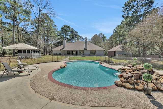 view of pool with a patio area, a fenced in pool, and fence