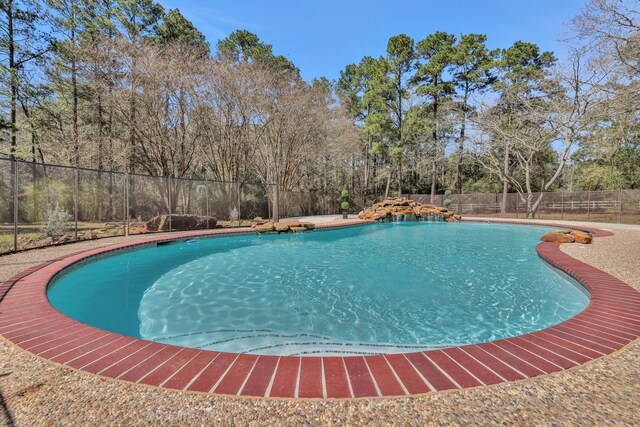 view of swimming pool with a fenced in pool and a fenced backyard