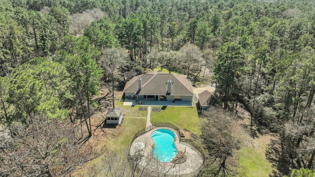 birds eye view of property with a wooded view