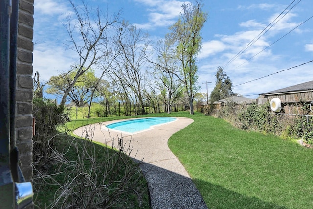 view of pool featuring a yard, a fenced in pool, and a fenced backyard