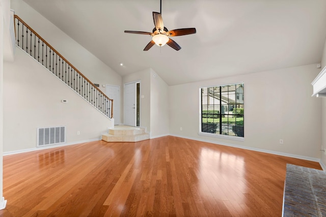 unfurnished living room featuring stairway, light wood-style floors, visible vents, and baseboards