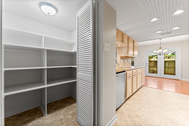 interior space featuring visible vents, a notable chandelier, backsplash, stainless steel dishwasher, and light countertops