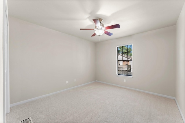 unfurnished room with light carpet, visible vents, ceiling fan, and baseboards