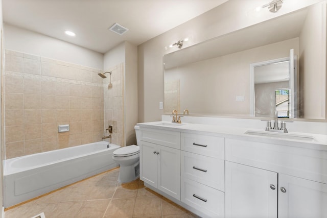 bathroom featuring tile patterned flooring, visible vents, toilet, and a sink