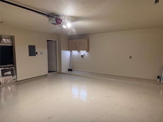 garage featuring electric panel, a garage door opener, and baseboards