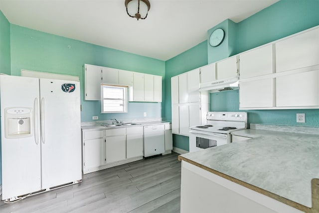 kitchen featuring under cabinet range hood, a sink, white appliances, white cabinets, and light countertops