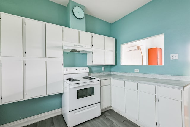 kitchen with a wall mounted AC, under cabinet range hood, white cabinetry, white range with electric stovetop, and light countertops