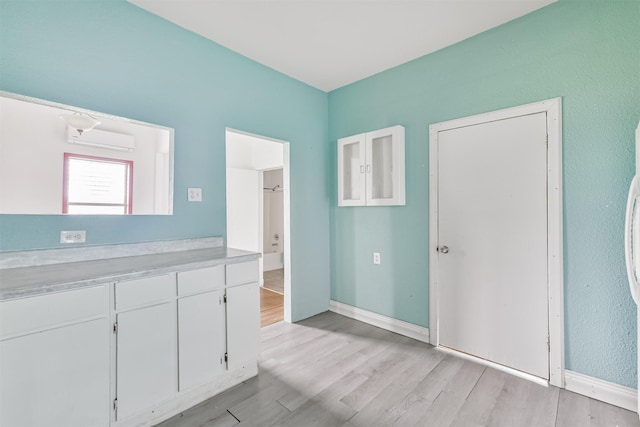 interior space with baseboards and light wood-type flooring