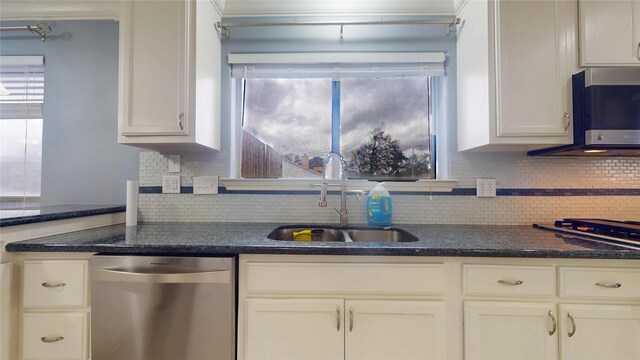 kitchen with white cabinetry, backsplash, appliances with stainless steel finishes, and a sink