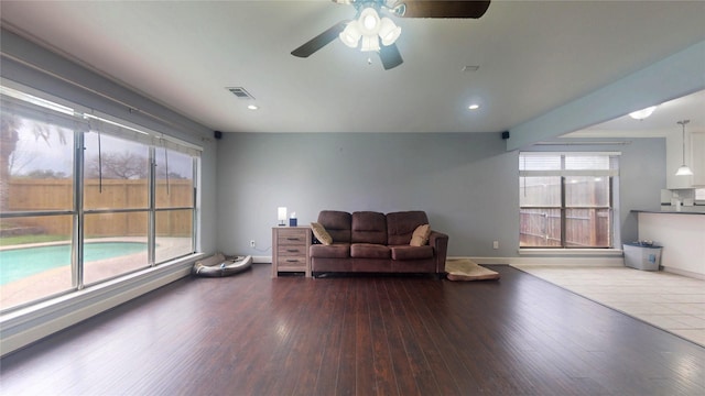 living area with visible vents, a ceiling fan, wood finished floors, recessed lighting, and baseboards