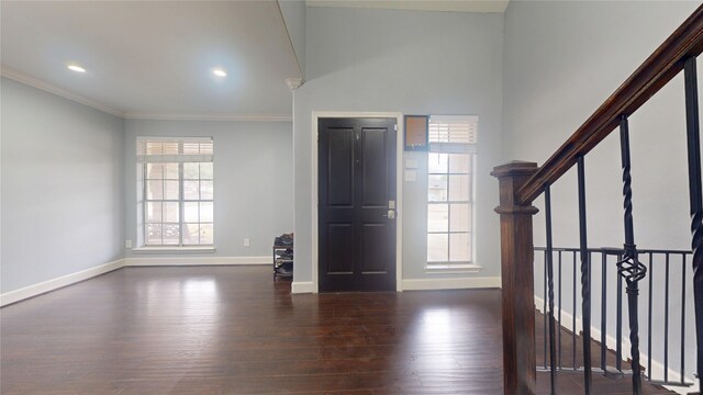 entrance foyer with plenty of natural light, stairs, baseboards, and wood finished floors