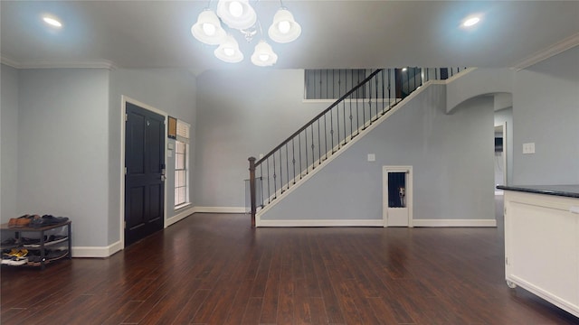 foyer featuring an inviting chandelier, stairway, wood finished floors, and baseboards