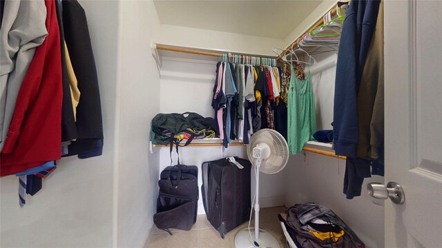 walk in closet with tile patterned floors