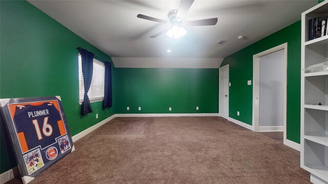 recreation room featuring a ceiling fan, carpet, visible vents, baseboards, and lofted ceiling