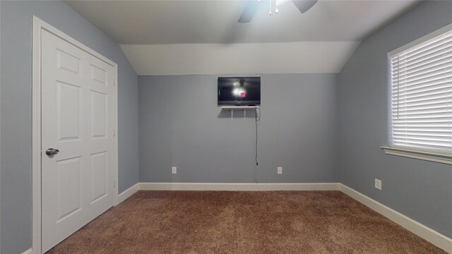 unfurnished bedroom with baseboards, carpet floors, and lofted ceiling